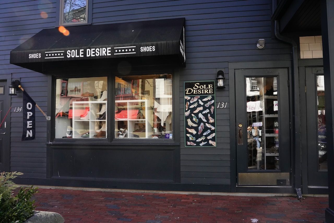 A black building with a black awning that says sole desire