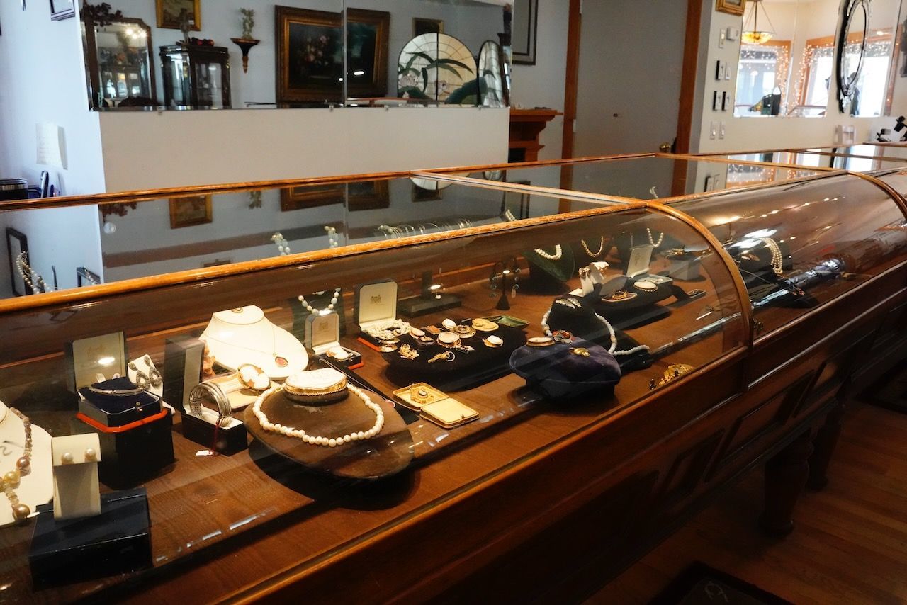 A display case with a lot of jewelry on it