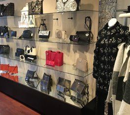 A display of handbags and a mannequin in a store