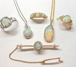 A group of opal jewelry including a necklace , ring , brooch and bracelet.