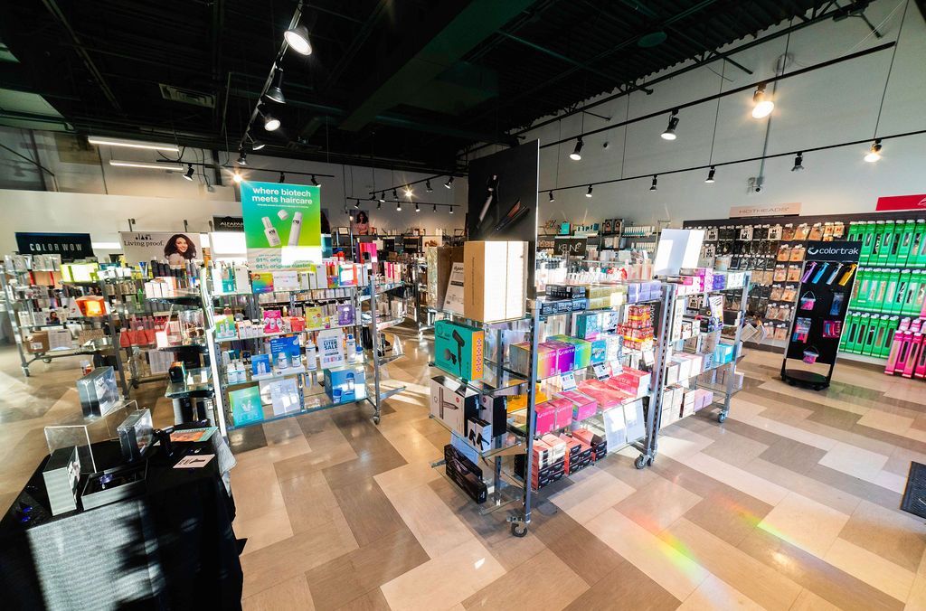 Interior of a retail store with shelves of products, bright lighting, and a patterned floor.