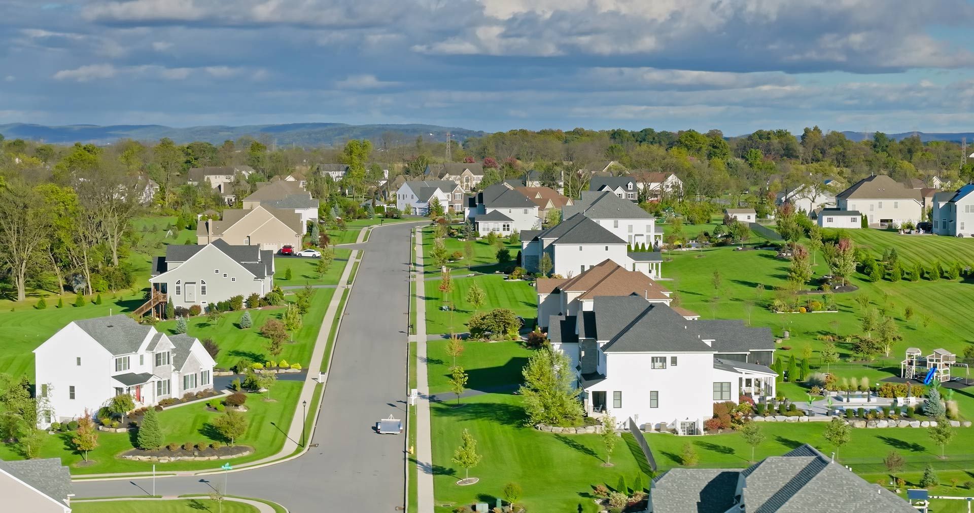 An aerial view of a residential neighborhood with lots of houses and trees