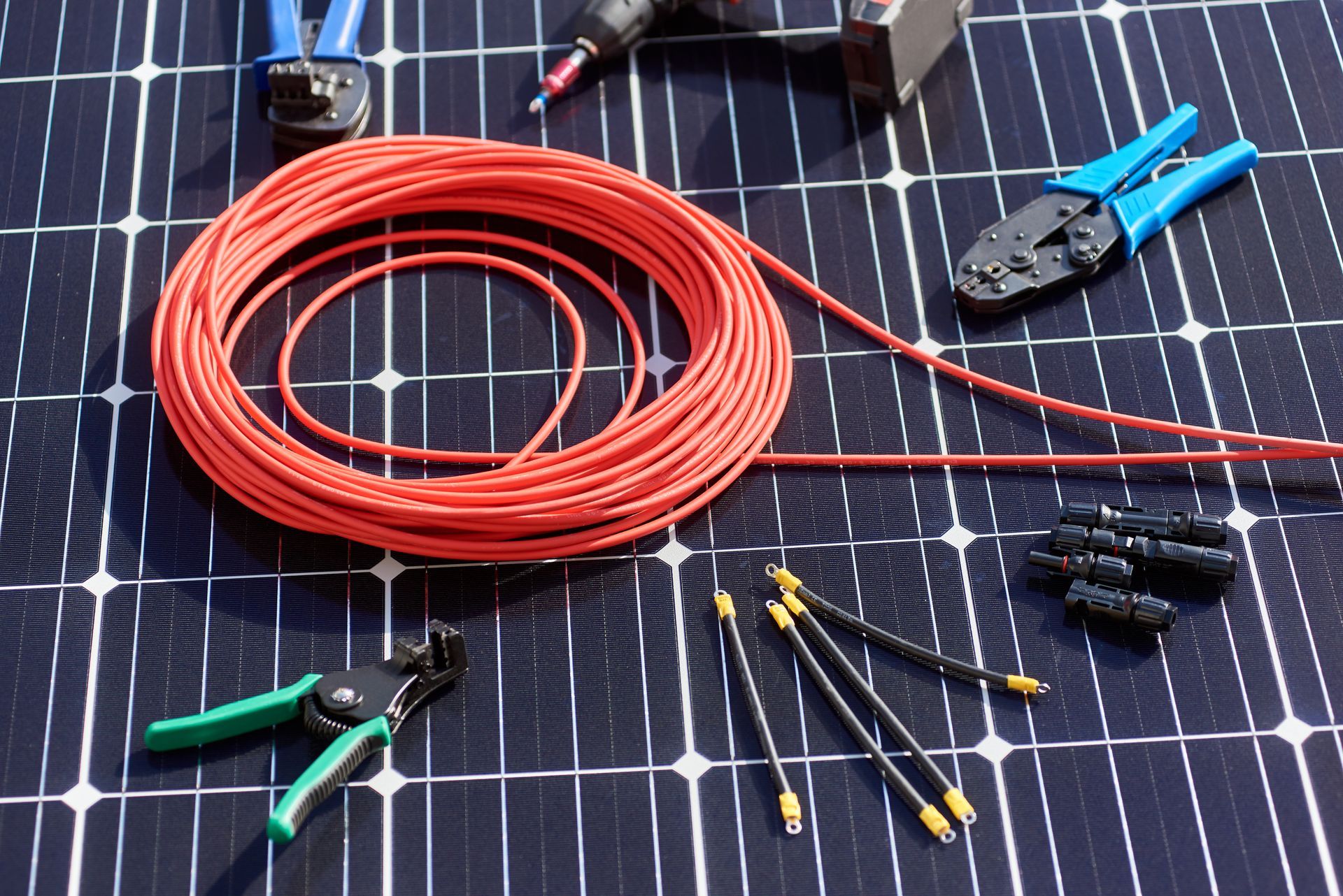 a bunch of tools are sitting on top of a solar panel .