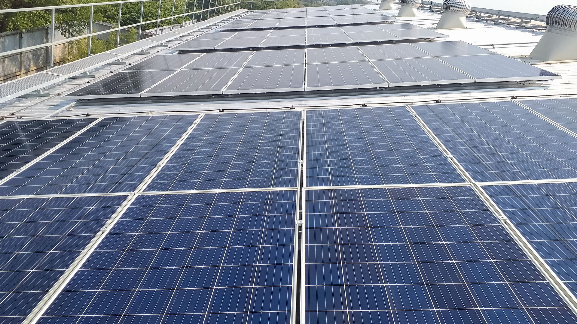 a row of solar panels on the roof of a building