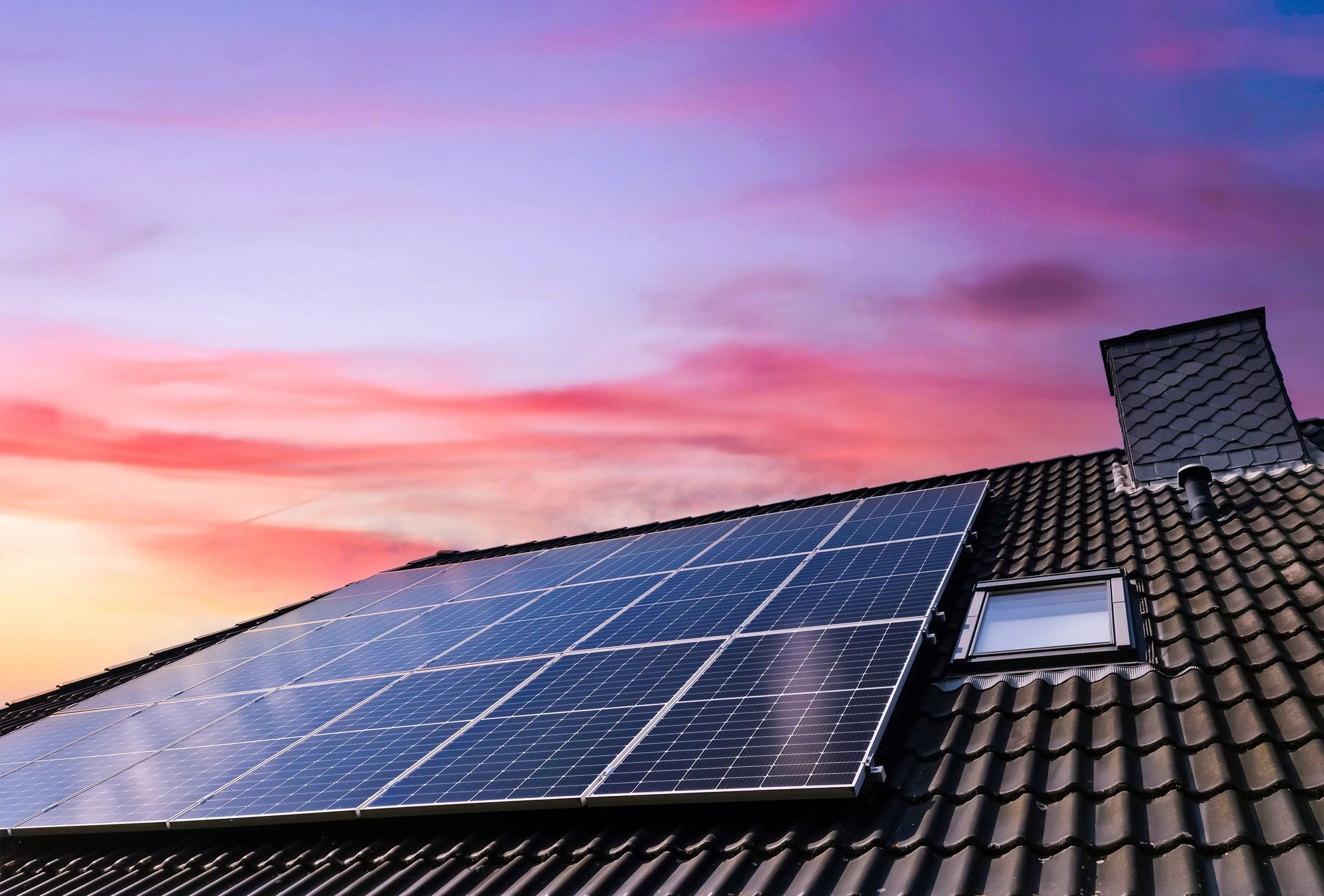 a row of solar panels on the roof of a house