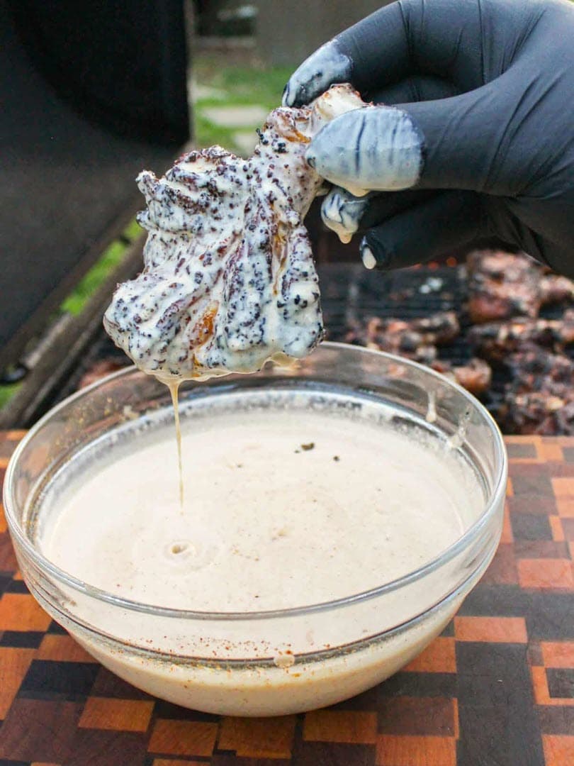 Chicken drumstick dipped in Alabama White Sauce