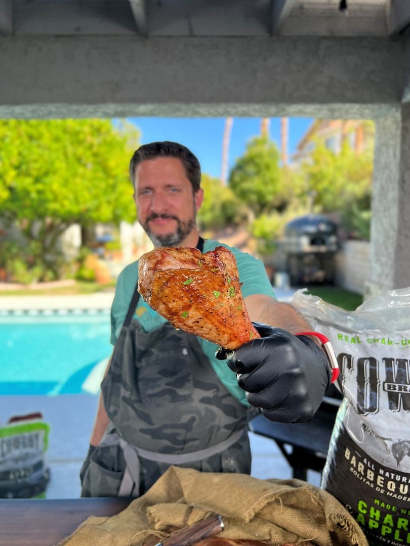 Pitmaster Dan Phelps holding a Brined Smoked Turkey Leg