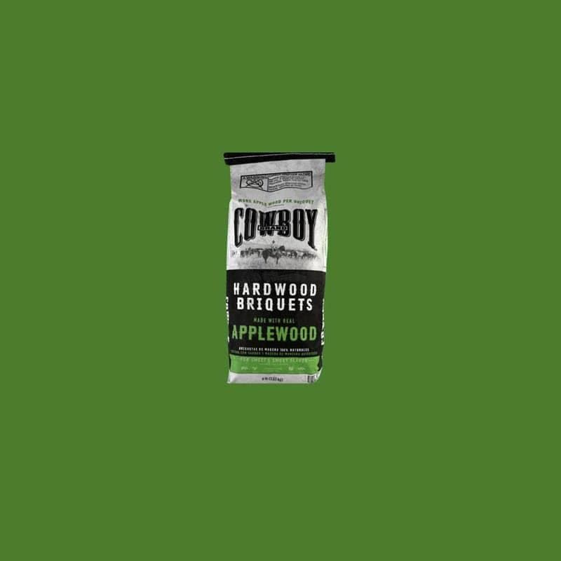 Bag of Cowboy hardwood briquets with applewood flavored charcoal on a green background.