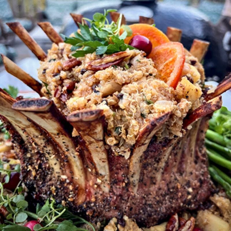 a large smoked crown of lamb with seasonings and garnish