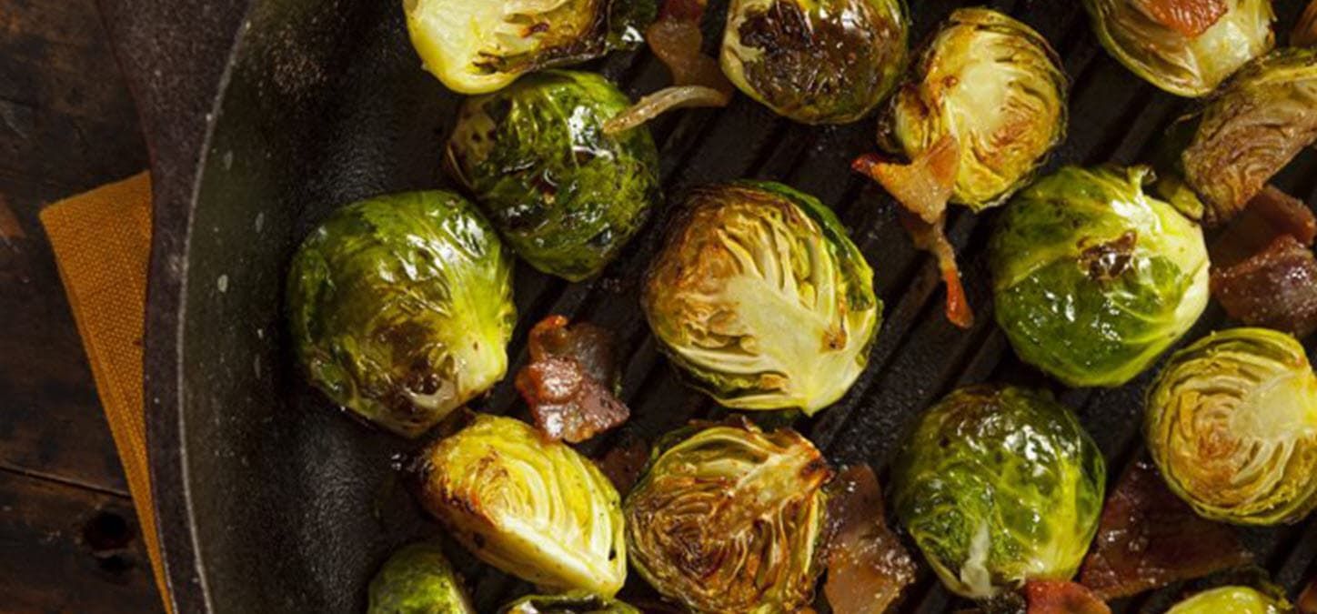 Brussels sprouts and bacon in cast iron pan; vegetables for grilling