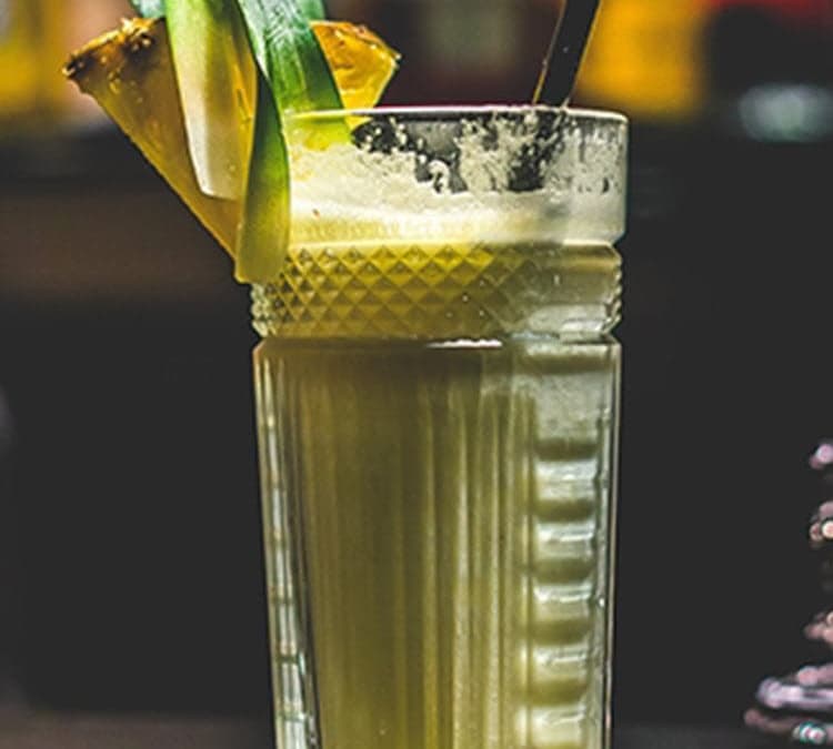 Grilled colada cocktail in tall glass with garnish