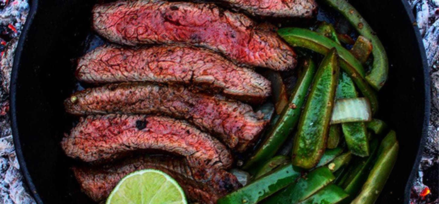 Flank steak, green bell peppers and a lime; Learn how to cook a steak in a cast iron skillet.