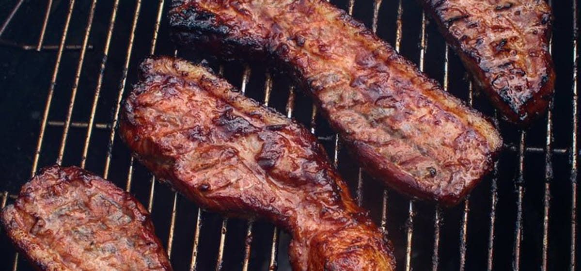pork belly cooking on the grill