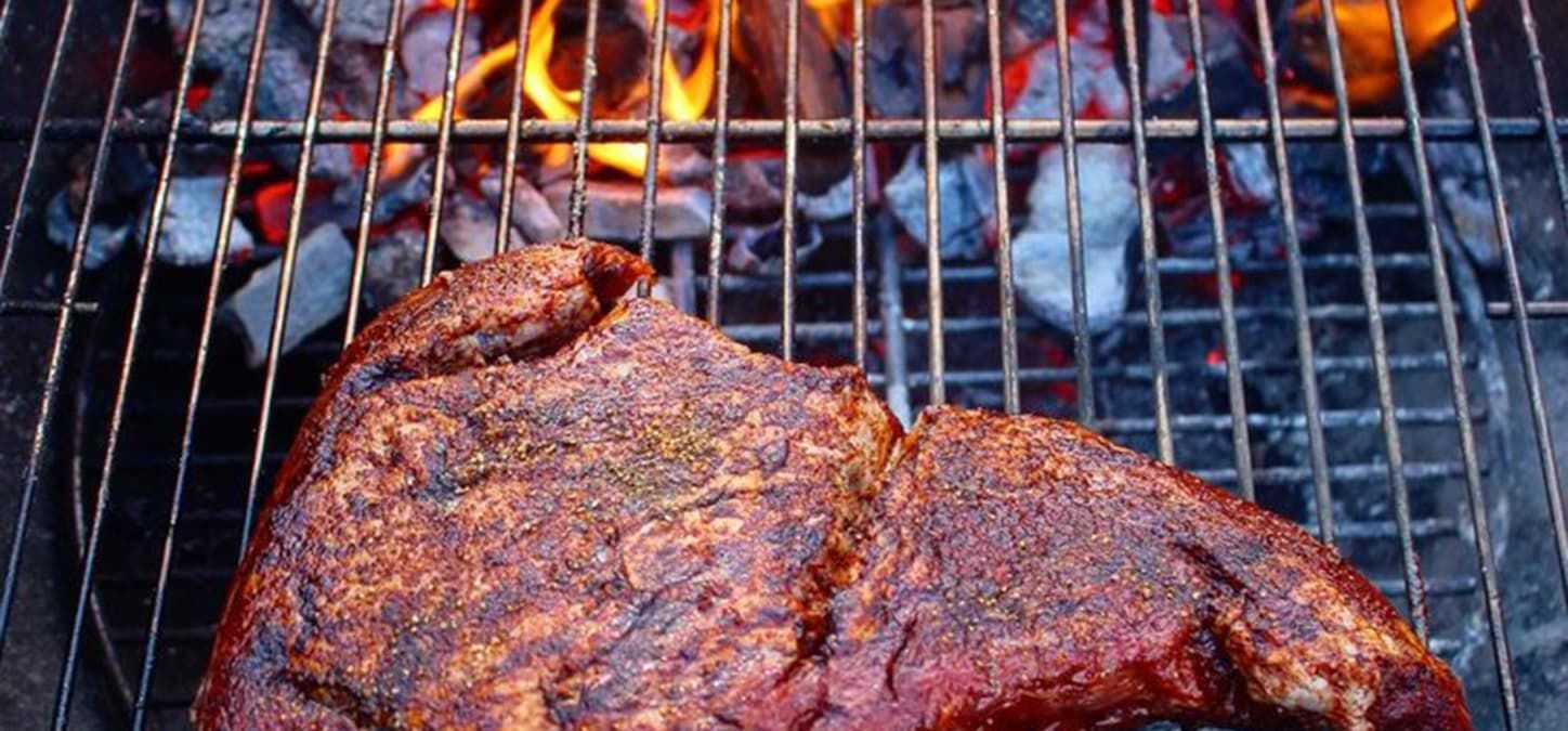tri-tip cooking over live fire grill