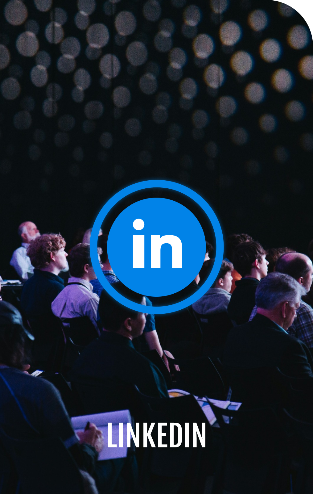 A group of people sitting in a dark room with a linkedin logo in the middle