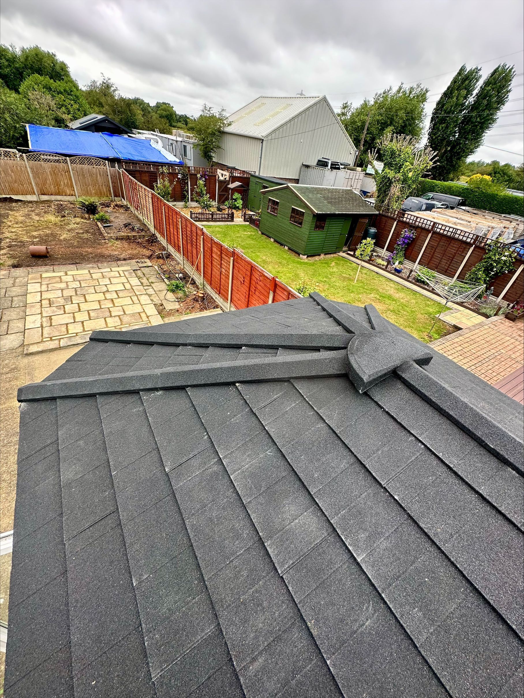 A close up of a roof with a fence in the background.