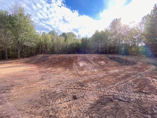 Muddy Open Field with Trees — Loganville, GA — Georgia's Best Clearing & Grading