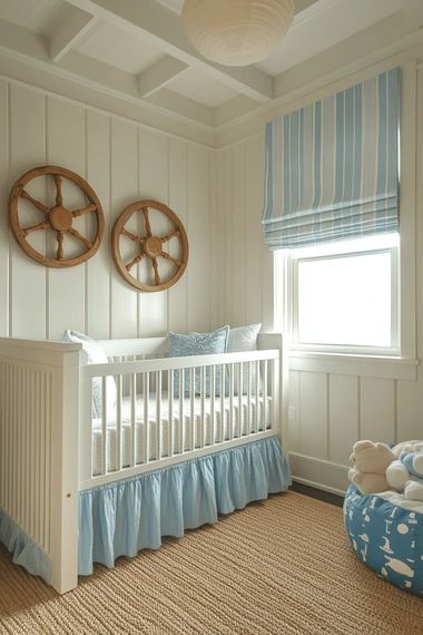 White crib with blue bedding in a beige nursery, with woven wall decor and a striped blue window shade.