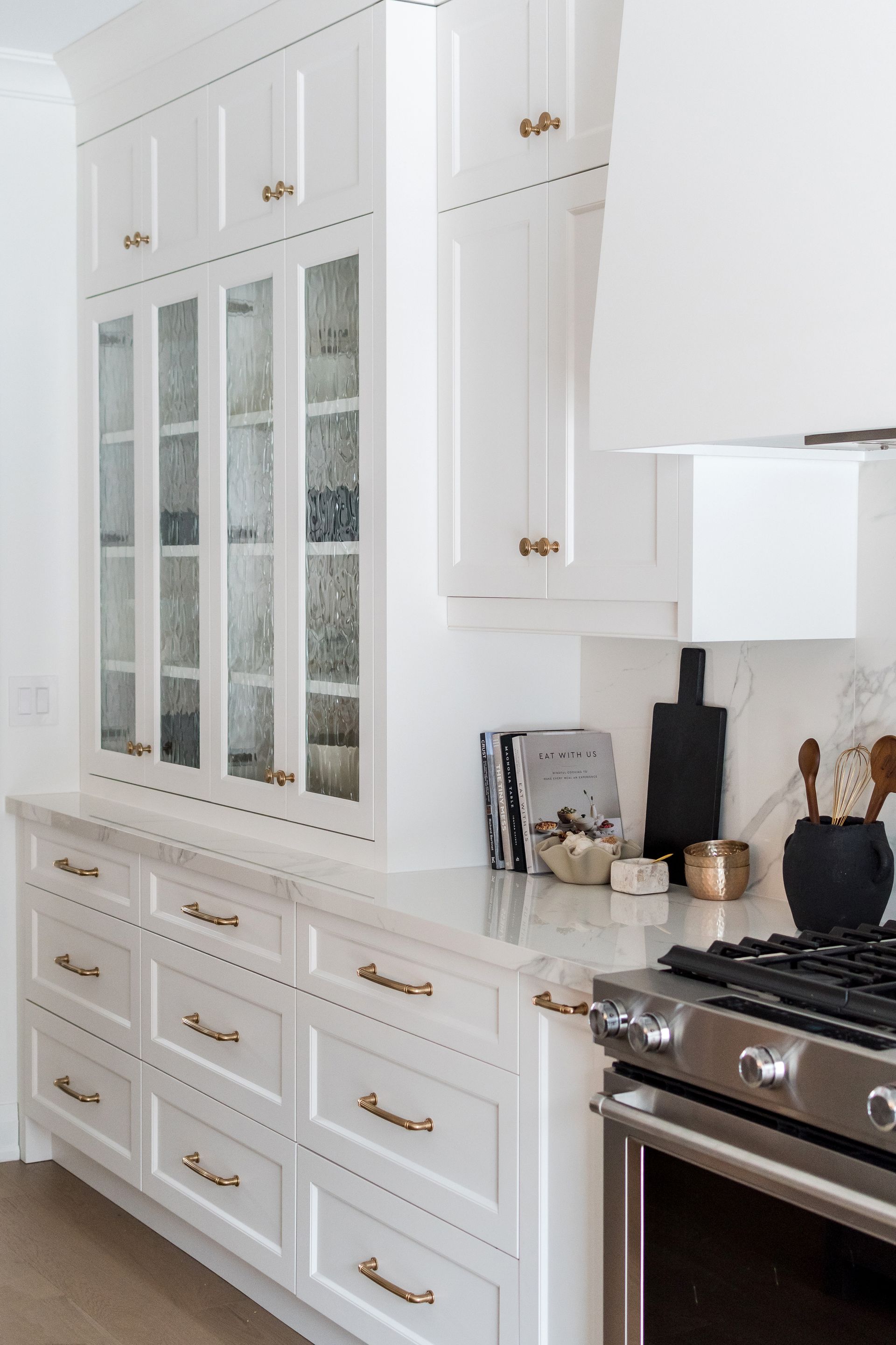 A kitchen with white cabinets and stainless steel appliances.