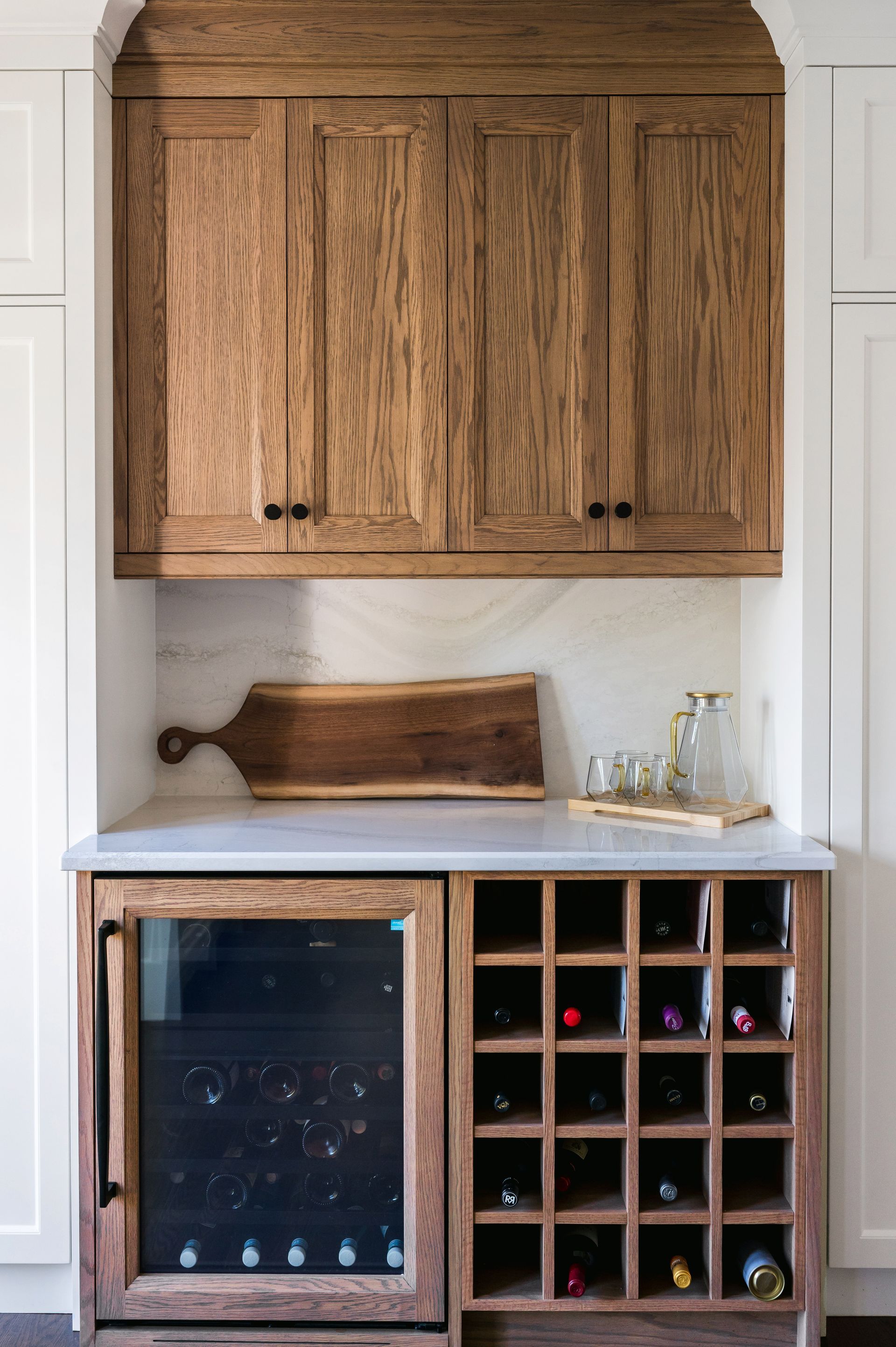 A kitchen with wooden cabinets and a wine cooler