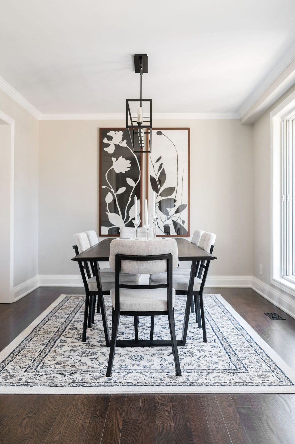 A dining room with a table and chairs and a rug
