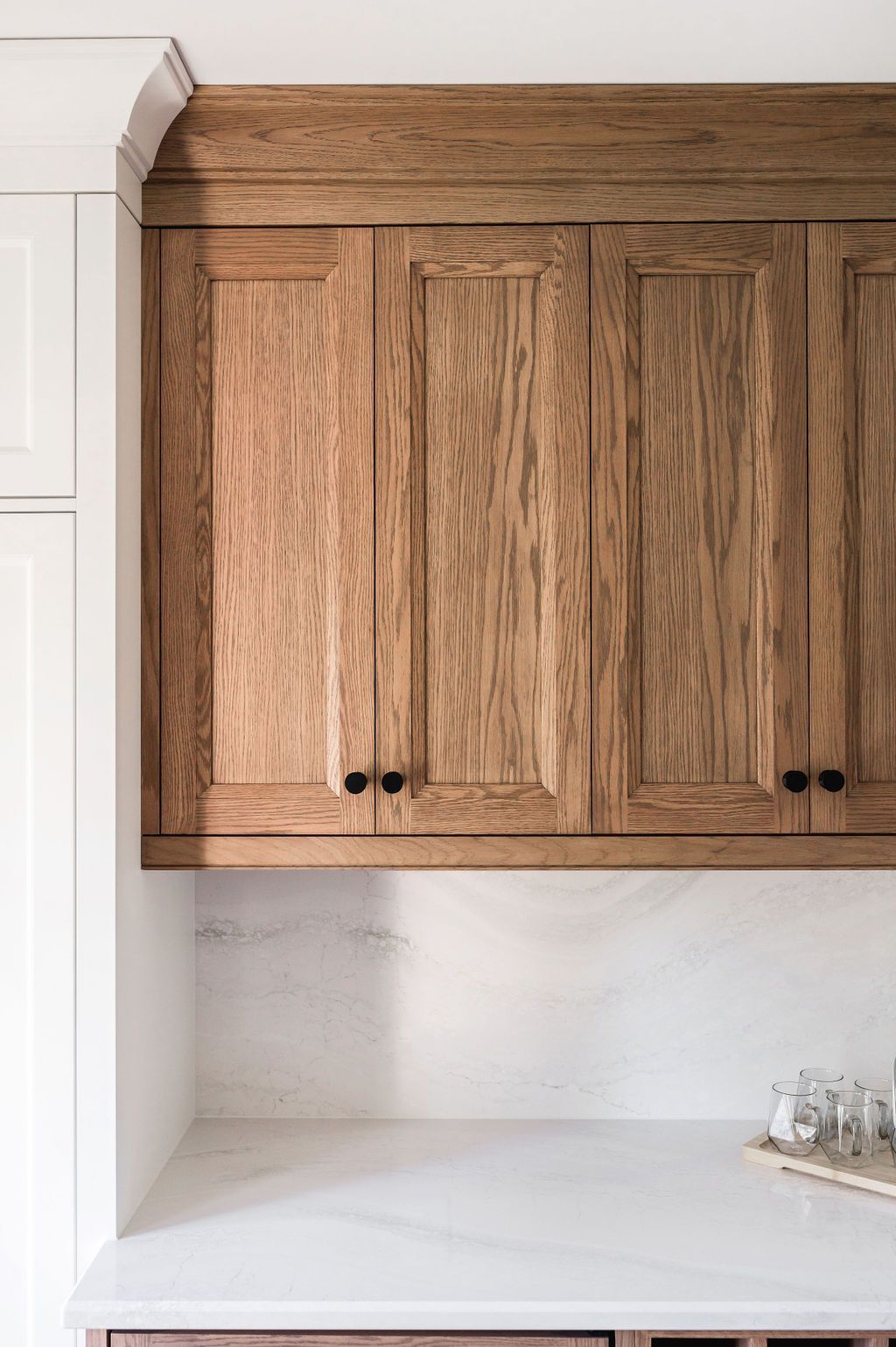A kitchen with wooden cabinets and a white counter top.