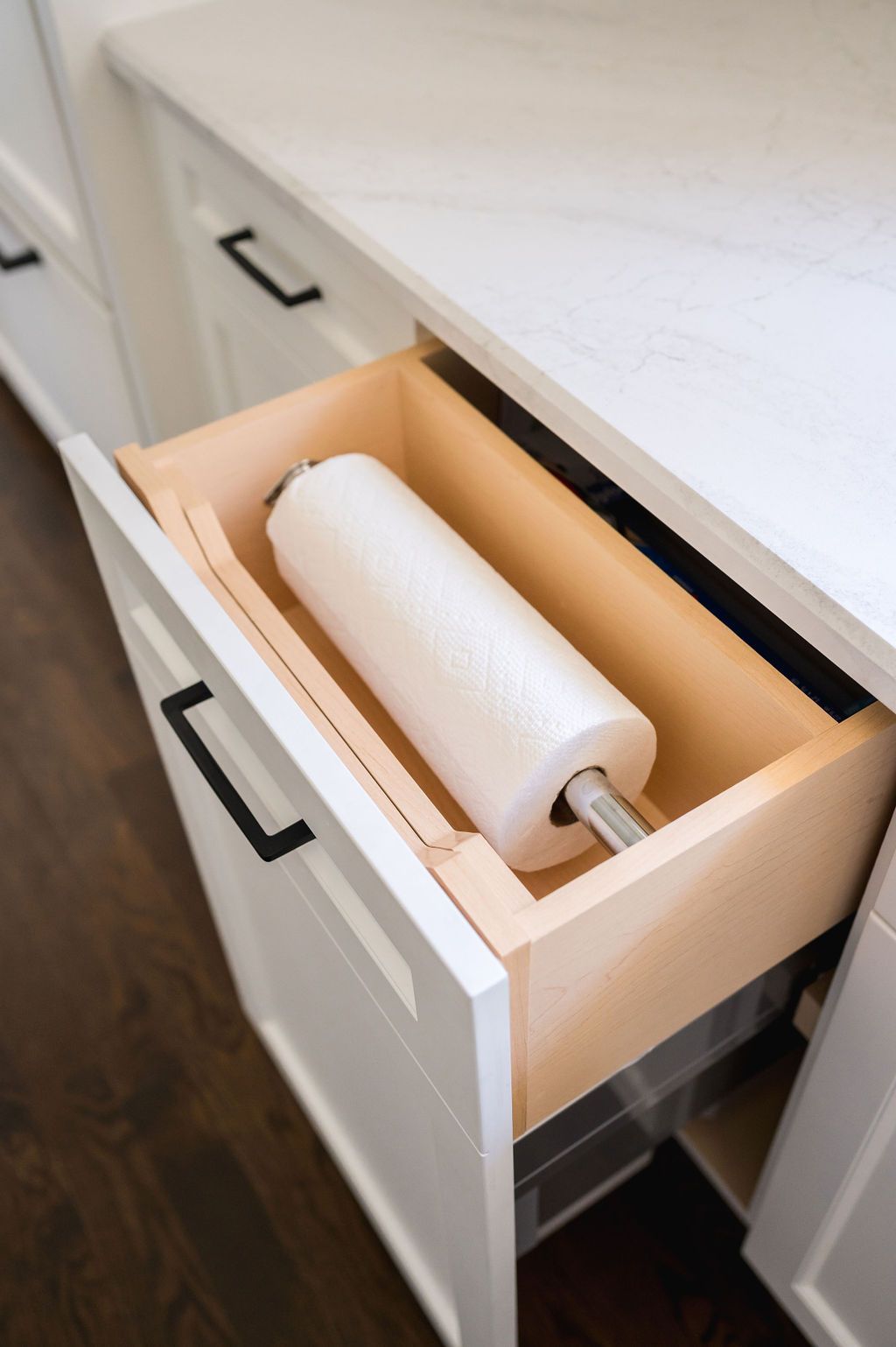 A roll of paper towels is sitting in a kitchen drawer.