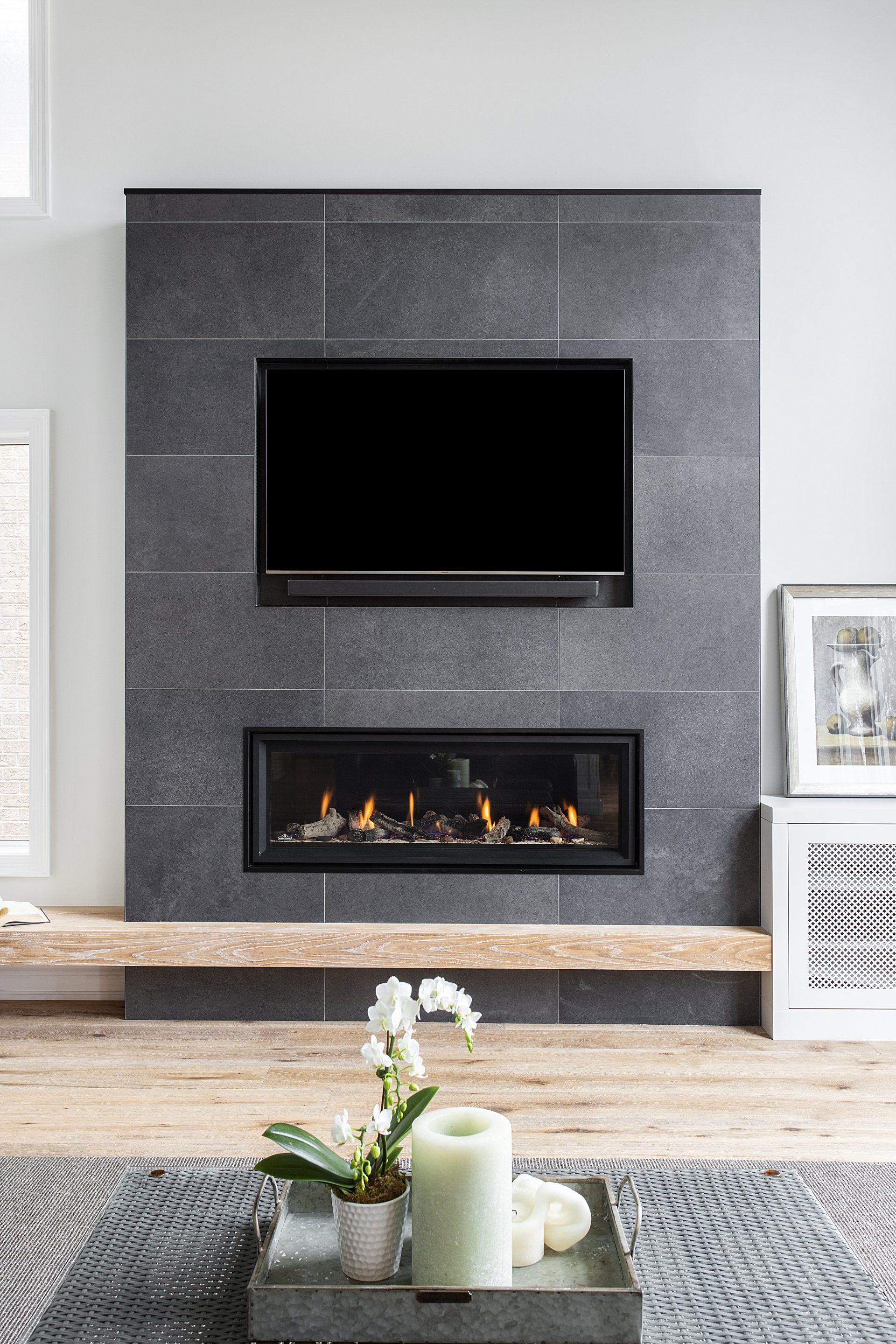A living room with a fireplace and a flat screen tv.