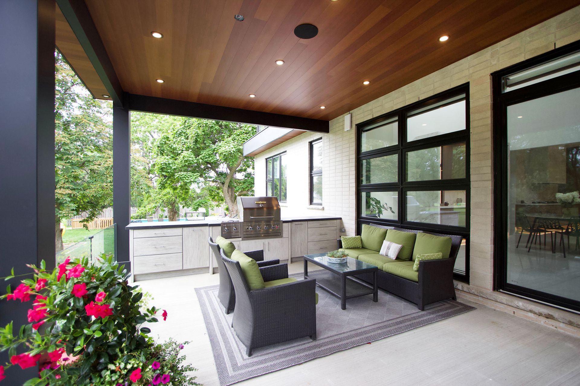 an outdoor kitchen with high top chairs