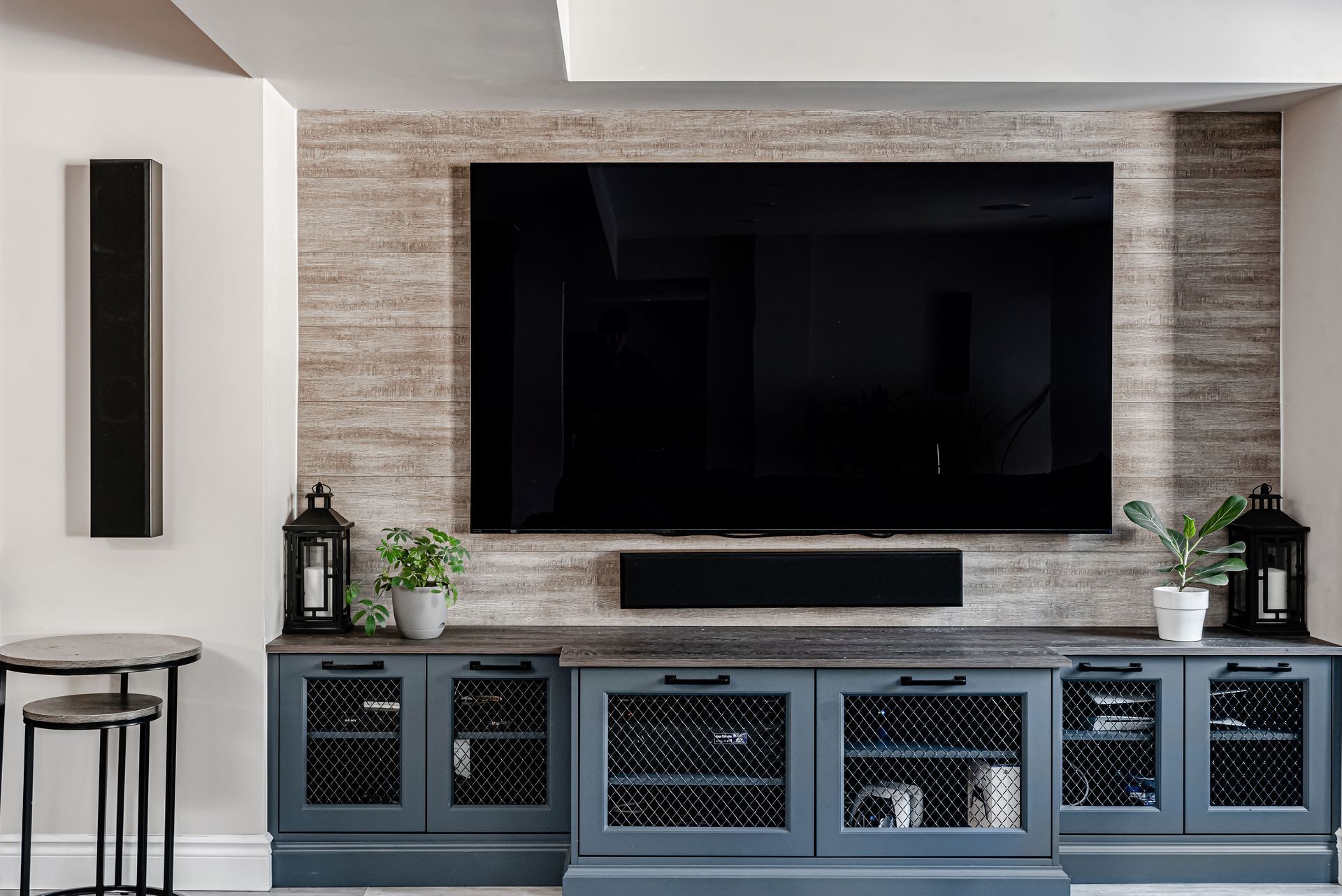 A living room with a large flat screen tv mounted on the wall.