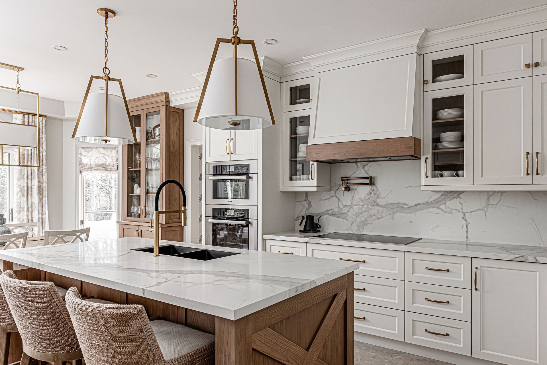 A kitchen with white cabinets and a large island.