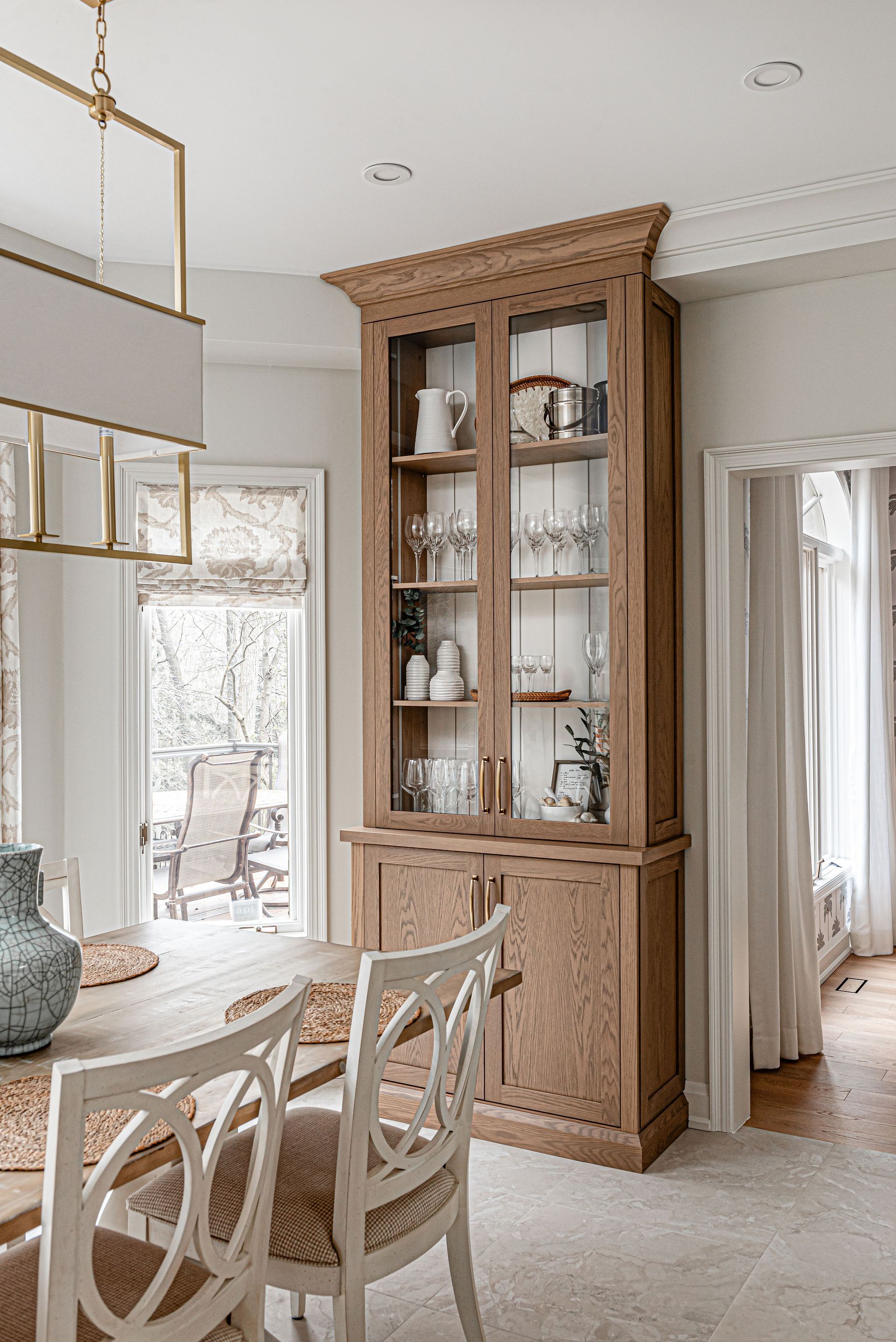 A dining room with a table and chairs and a hutch.