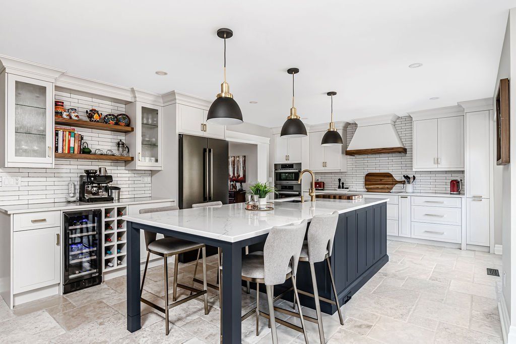 A large kitchen with a large island and a dining table.