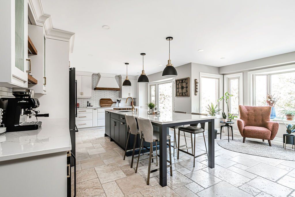 A kitchen , dining room , and living room in a large house.