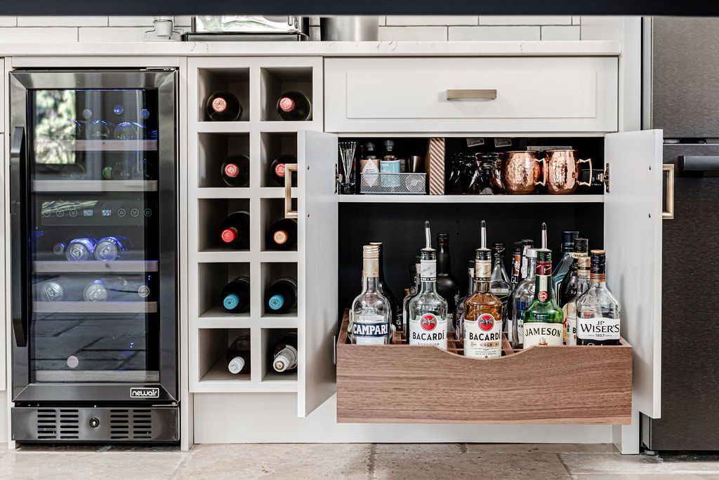 A kitchen with a wine cooler and a wine rack.