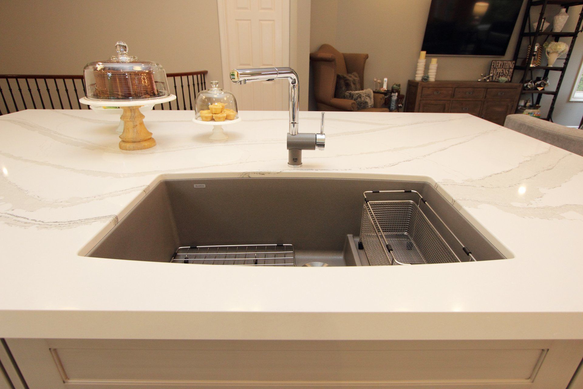 A kitchen sink is sitting on top of a white counter.