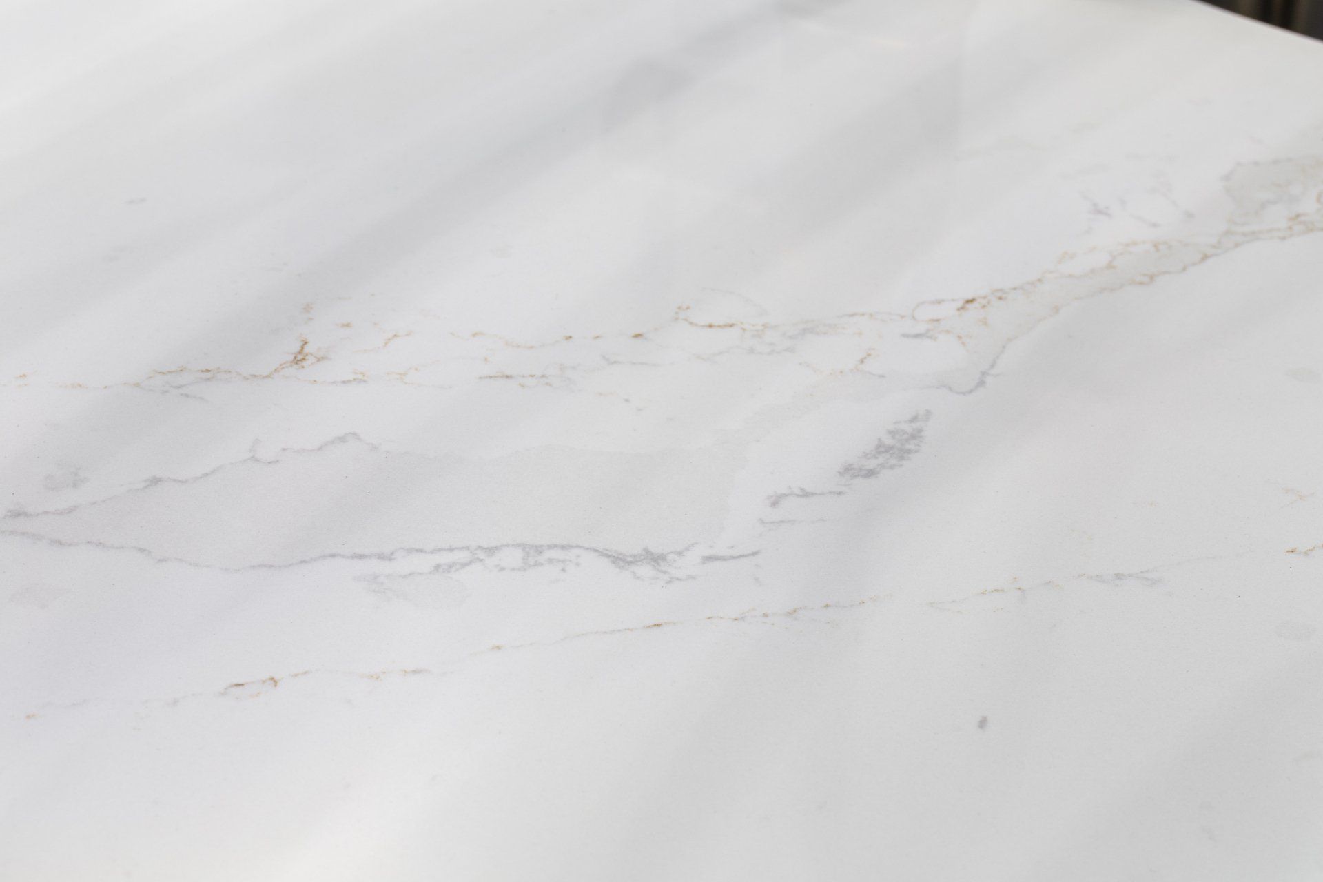 A close up of a white marble counter top.