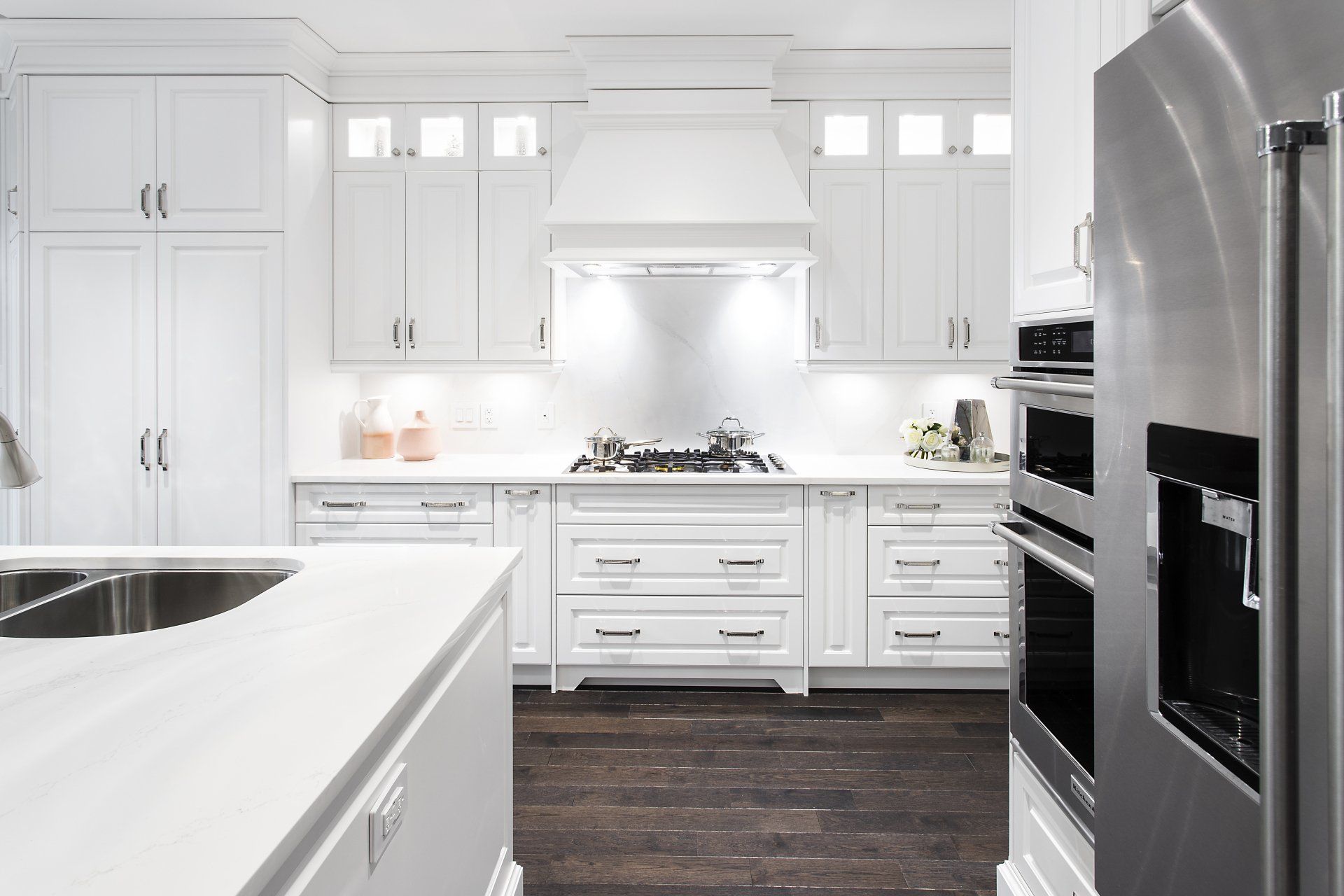 A kitchen with white cabinets and stainless steel appliances