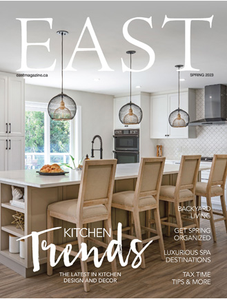 A kitchen with a large island and chairs on the cover of a magazine.