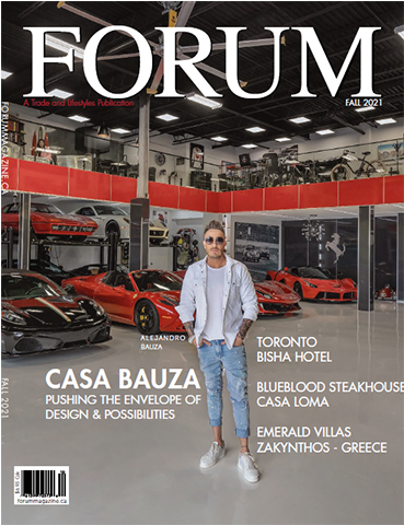 A man is standing in front of a garage full of cars on the cover of a magazine.