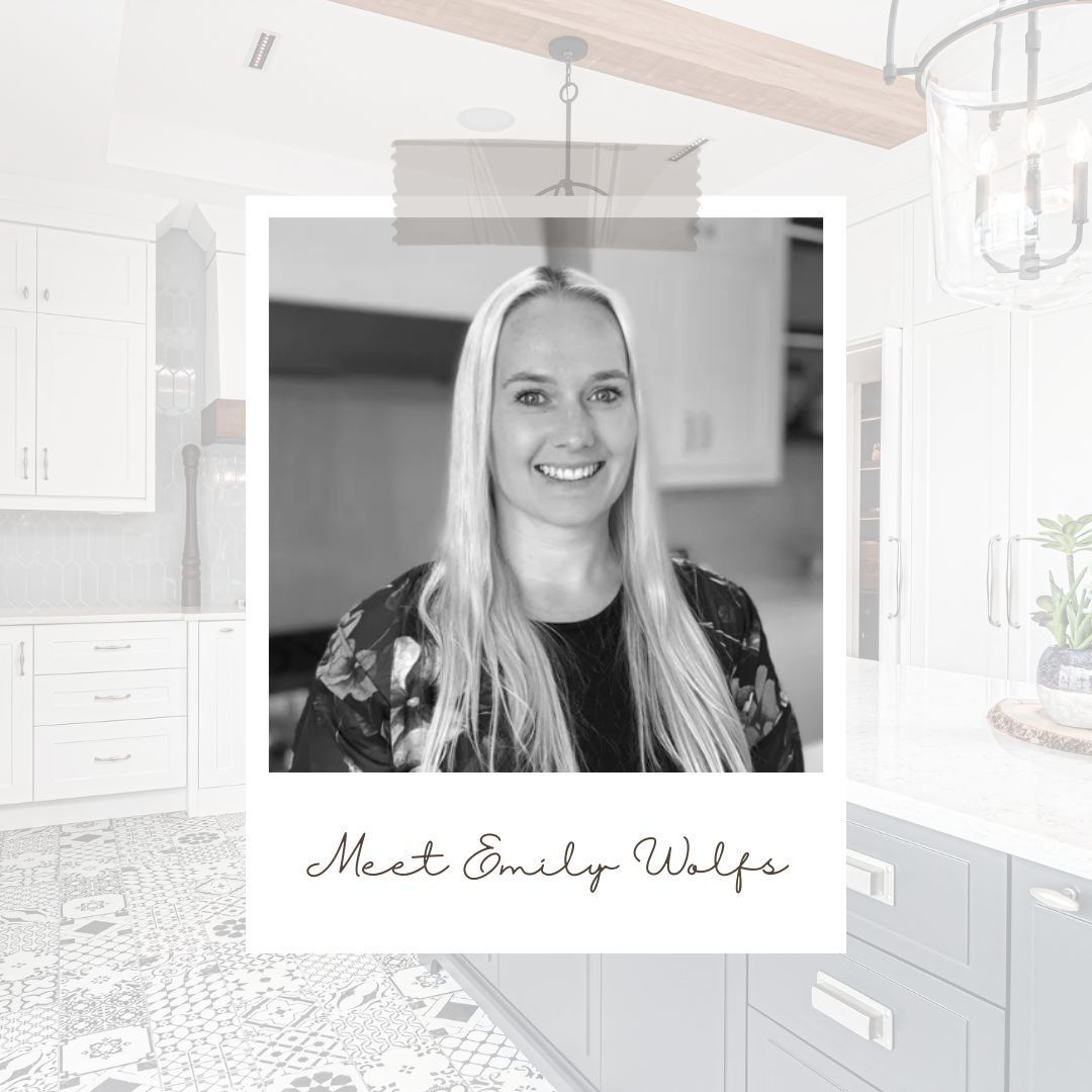 A black and white photo of a woman in a kitchen.