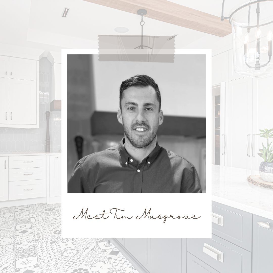 A black and white photo of a man in a kitchen.