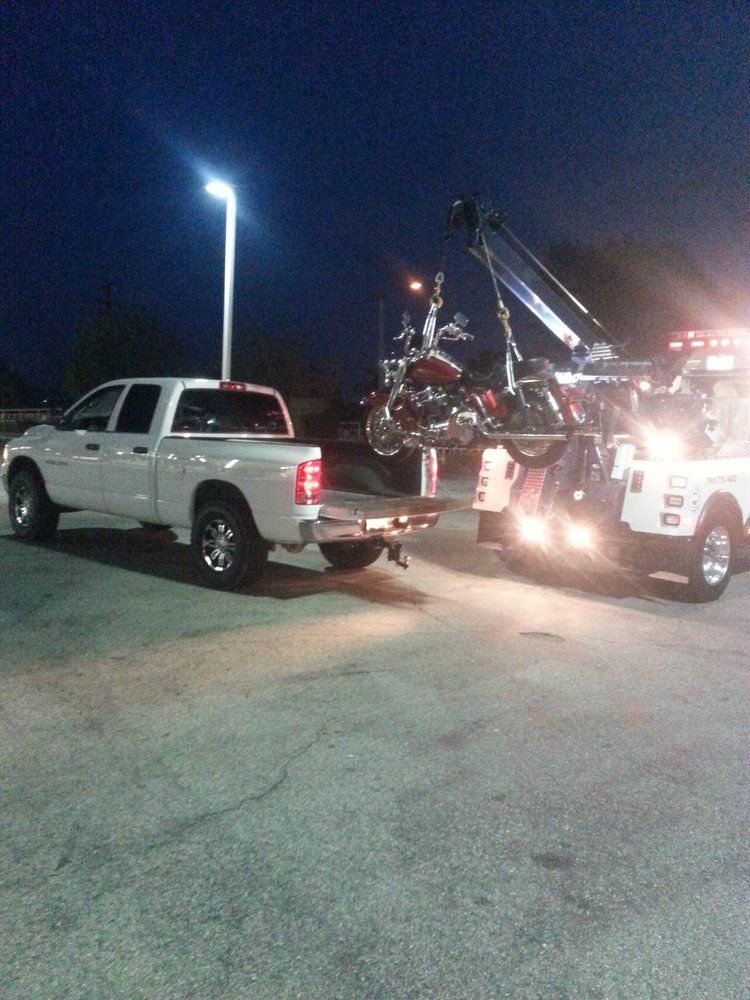 A motorcycle is being towed by a tow truck