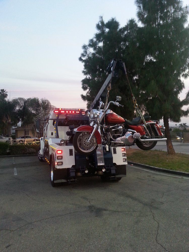 A motorcycle is being towed by a tow truck