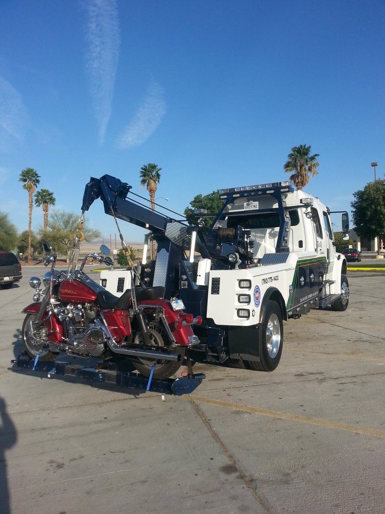 A motorcycle is being towed by a tow truck
