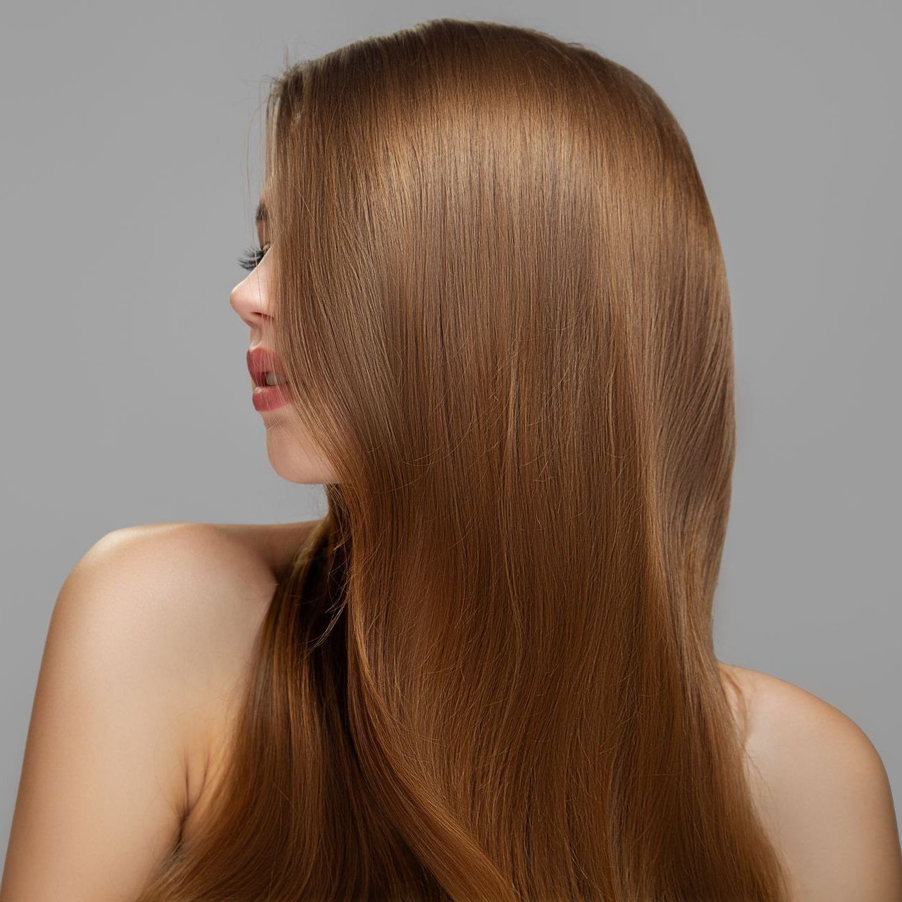 A woman with long brown hair is standing