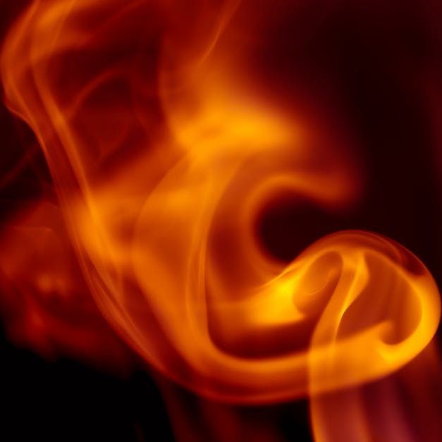 Swirling orange and red flames against a black background.