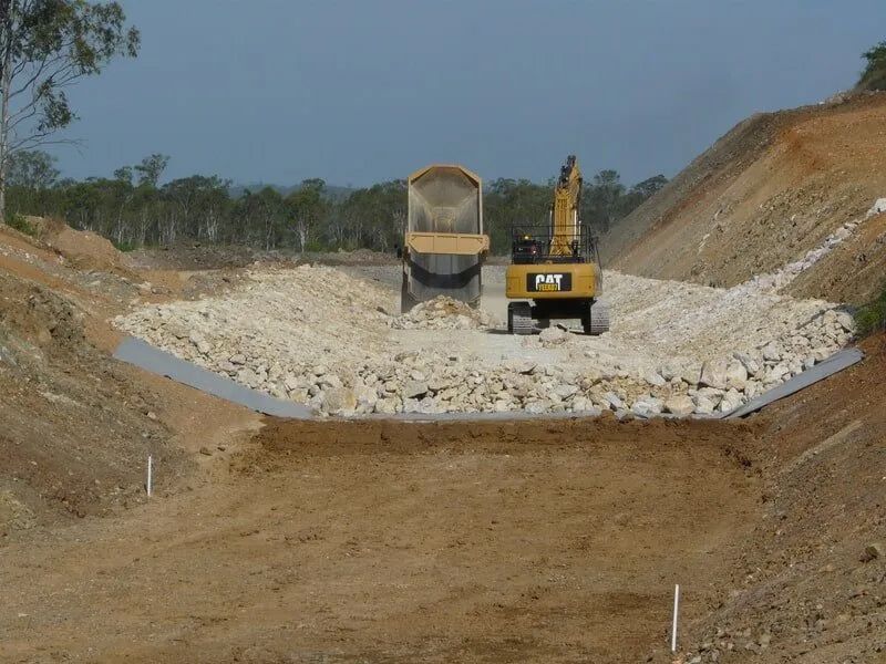 Dump Truck Is Unloading a Load of Rocks — Mike Barlow Earthmoving Pty Ltd in Rockhampton, QLD