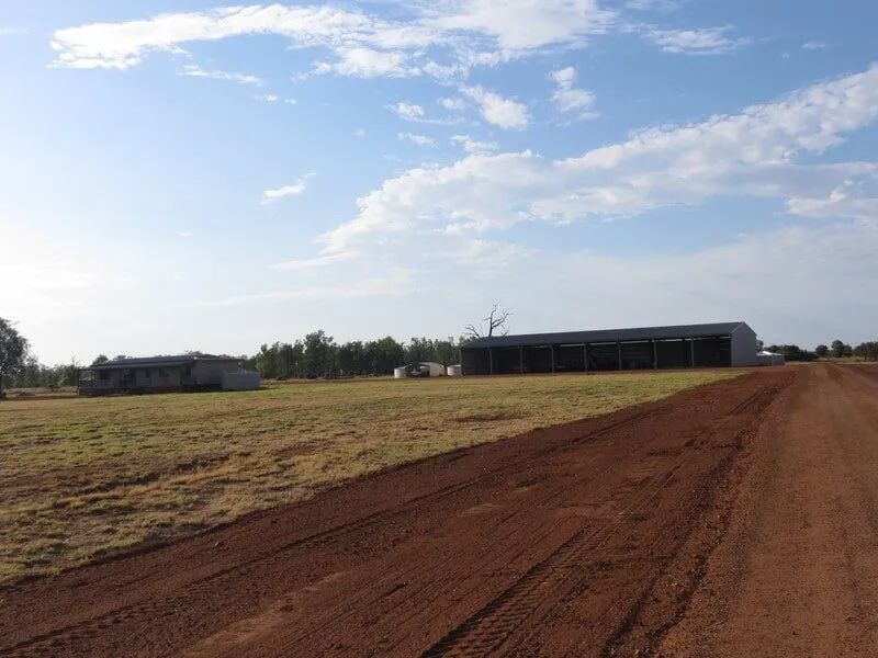 Dirt Rough Road Passing By A Shed — Mike Barlow Earthmoving Pty Ltd in Rockhampton, QLD