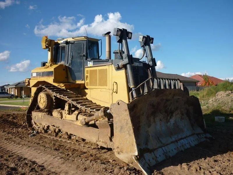 Yellow Bulldozer Parked On Dirt Ground After Land Cleaning — Mike Barlow Earthmoving Pty Ltd in Rockhampton, QLD